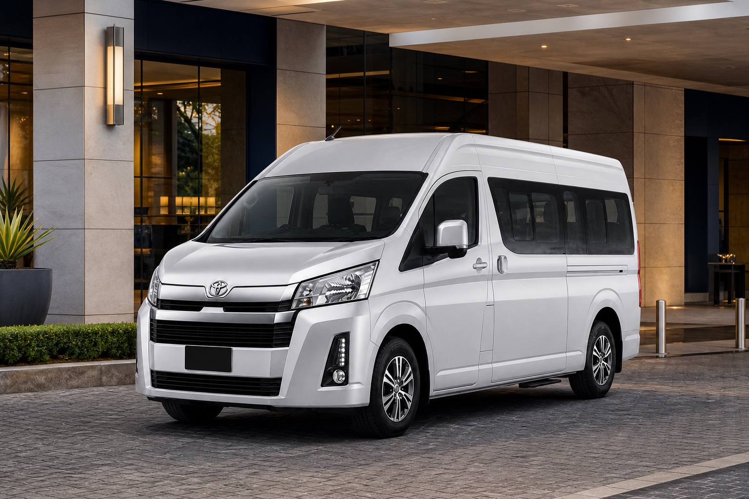 Silver new-shape Toyota Quantum GL at a premium hotel entrance